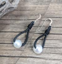 Earrings: white FWP on black leather by Myra Gadson
