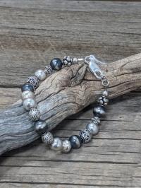 Detailed sterling silver and oxidized sterling silver beads combine to form a beautiful bracelet. by Suzanne Woodworth